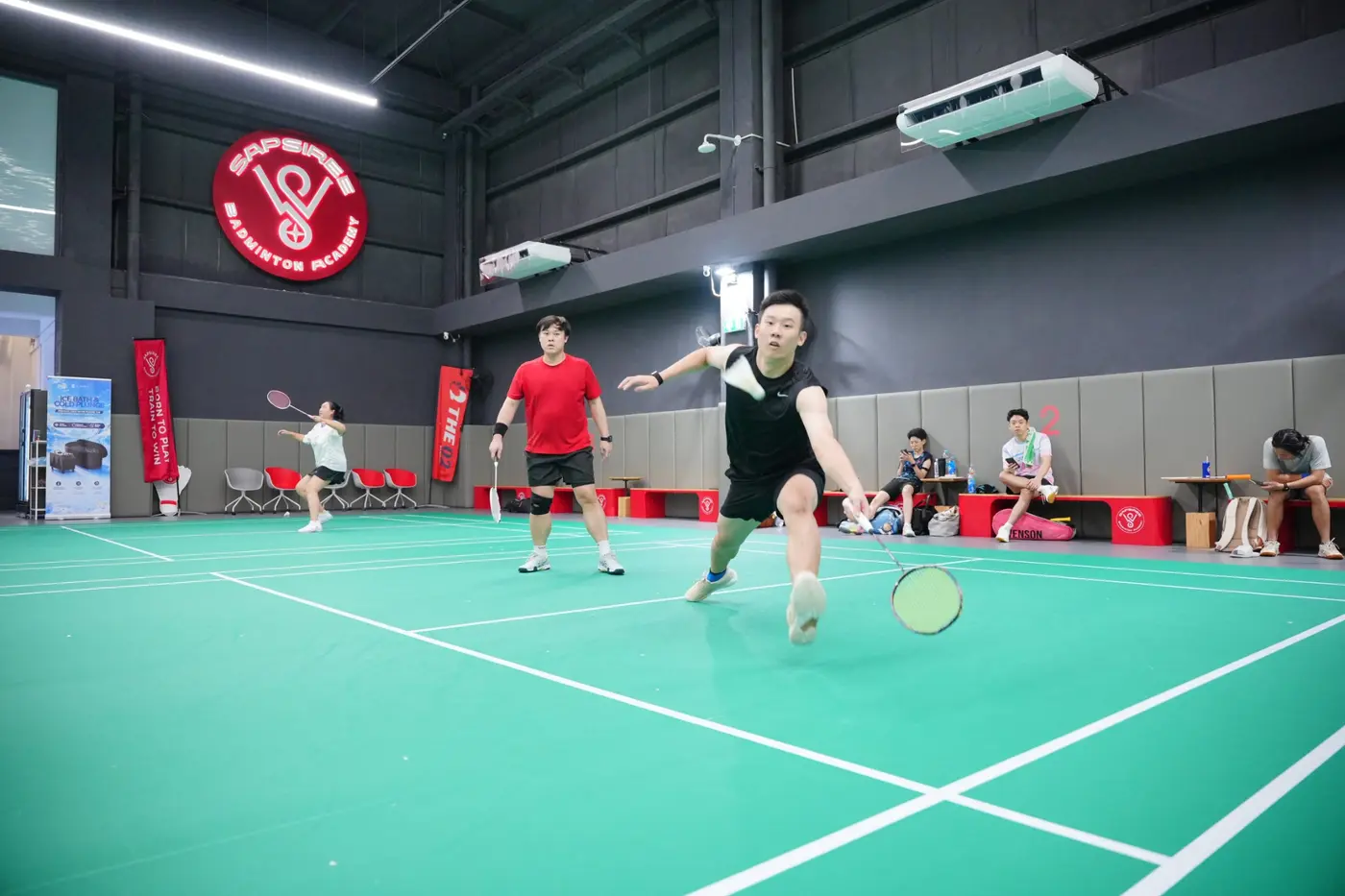 Badminton player lunging during a training session at Sapsiree Badminton Academy