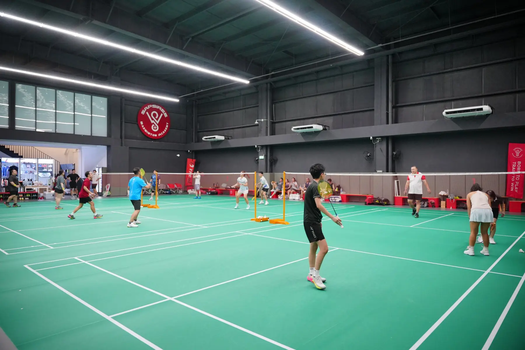Seven professional air-conditioned badminton courts at Sapsiree Badminton Academy