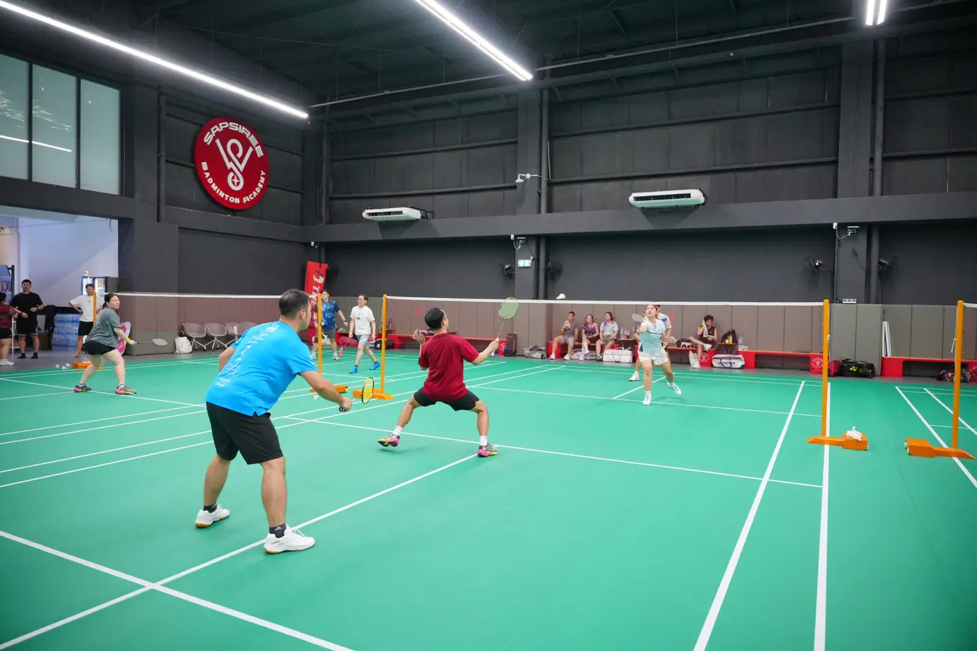 Junior badminton training session at Sapsiree Badminton Academy